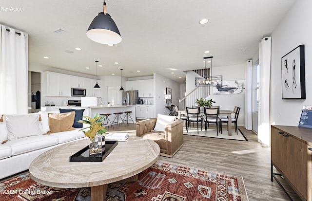 living room with hardwood / wood-style flooring and sink