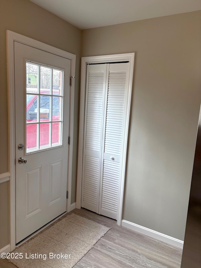 doorway to outside with light wood-type flooring