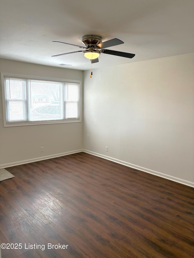 spare room featuring plenty of natural light and dark hardwood / wood-style floors