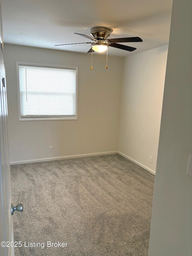 carpeted empty room featuring ceiling fan