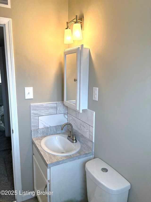 bathroom with vanity and toilet