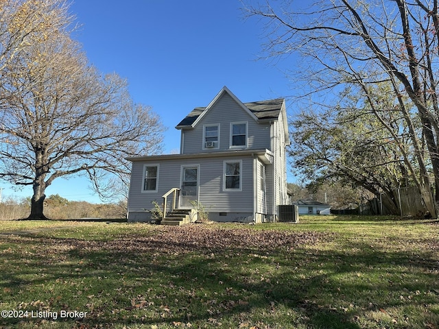 view of front of home with central AC and a front lawn