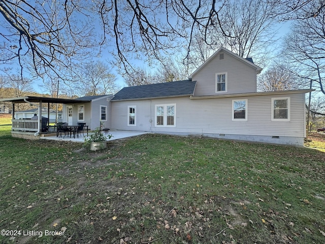 back of house with a yard and a patio area