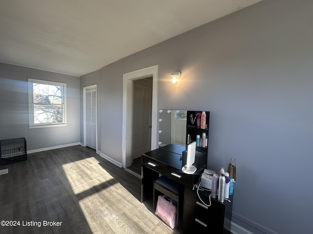 interior space with dark wood-type flooring and a closet