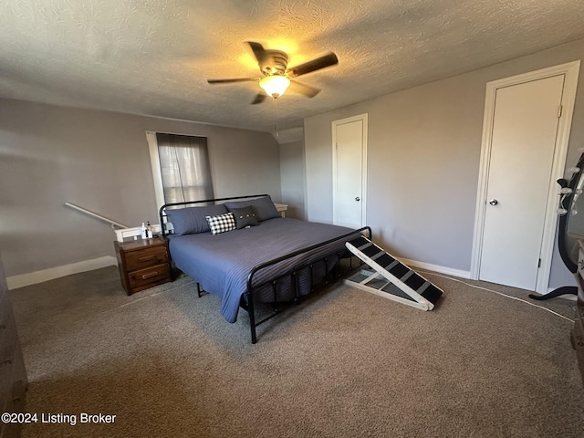 bedroom with ceiling fan, carpet flooring, and a textured ceiling