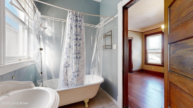 bathroom featuring tile patterned flooring, shower / bath combo, and sink