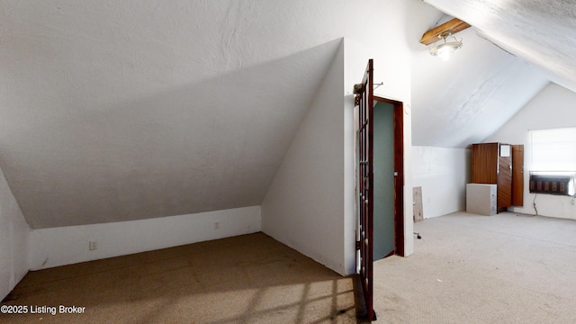 additional living space with lofted ceiling, light carpet, heating unit, and a textured ceiling