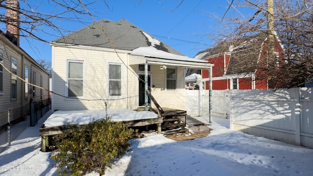 snow covered house with a porch