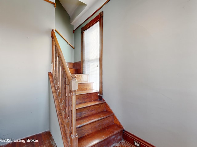 stairs featuring hardwood / wood-style flooring