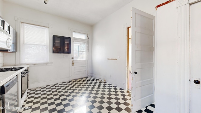 kitchen featuring tile counters, dishwasher, and stove