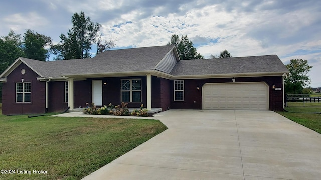 single story home featuring a garage and a front lawn