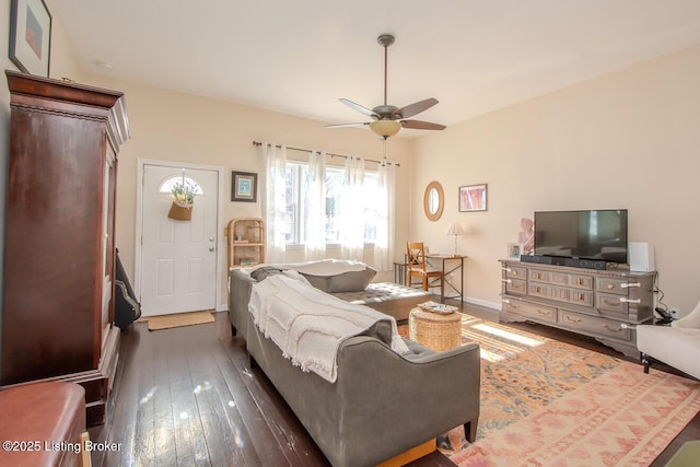 living room with dark wood-type flooring and ceiling fan