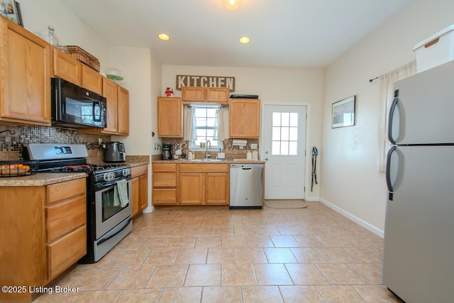 kitchen featuring light tile patterned flooring, stainless steel appliances, sink, and backsplash