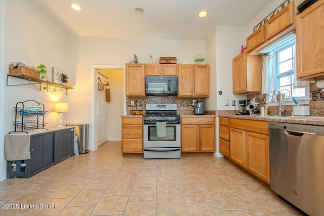 kitchen featuring light brown cabinetry, backsplash, stainless steel appliances, and light tile patterned flooring