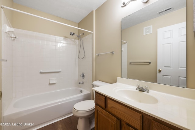 full bathroom featuring vanity, wood-type flooring,  shower combination, and toilet