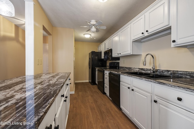 kitchen featuring sink, dark stone countertops, black appliances, white cabinets, and dark hardwood / wood-style flooring