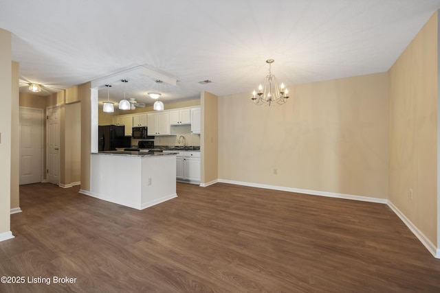 kitchen with white cabinetry, sink, dark hardwood / wood-style flooring, hanging light fixtures, and black appliances