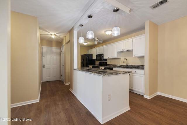 kitchen featuring decorative light fixtures, white cabinets, dark hardwood / wood-style flooring, and black appliances