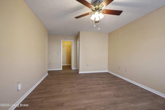 empty room with dark hardwood / wood-style flooring, a textured ceiling, and ceiling fan