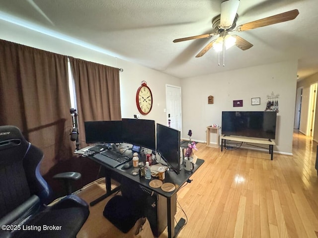 office with ceiling fan, light hardwood / wood-style floors, and a textured ceiling