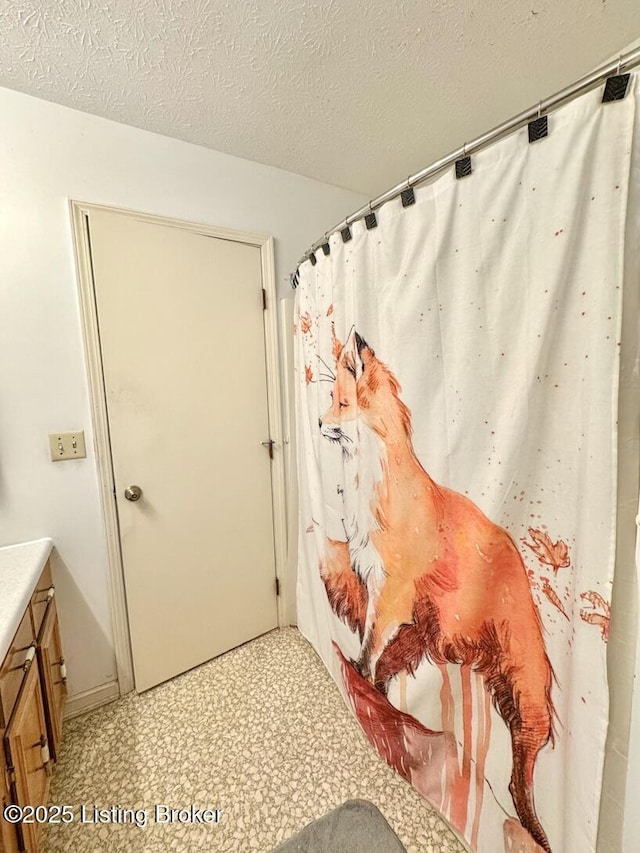 bathroom with vanity and a textured ceiling