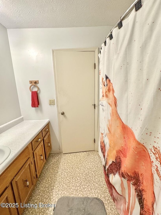 bathroom featuring vanity and a textured ceiling