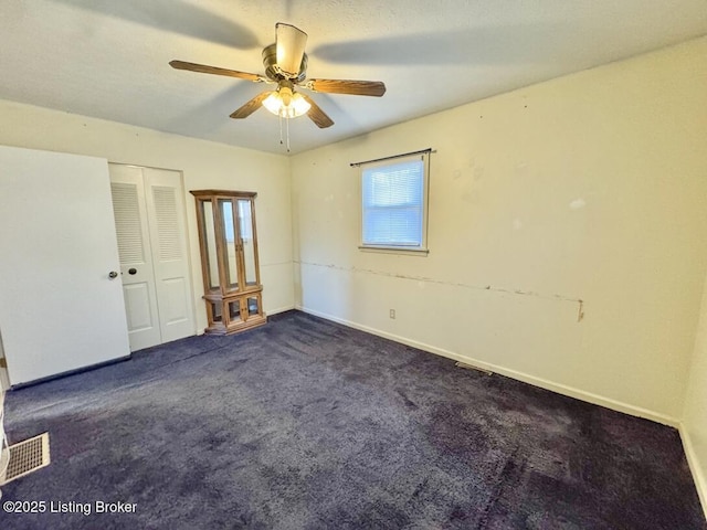 carpeted empty room with ceiling fan