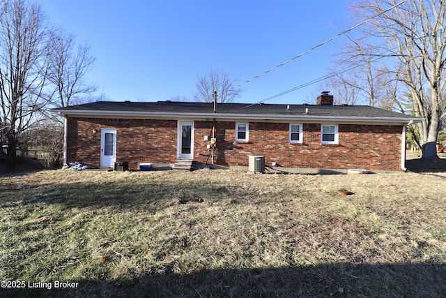 back of property with a yard and central air condition unit