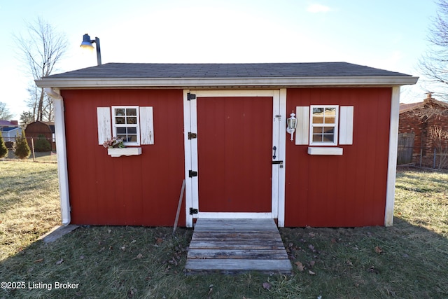 view of outbuilding featuring a lawn