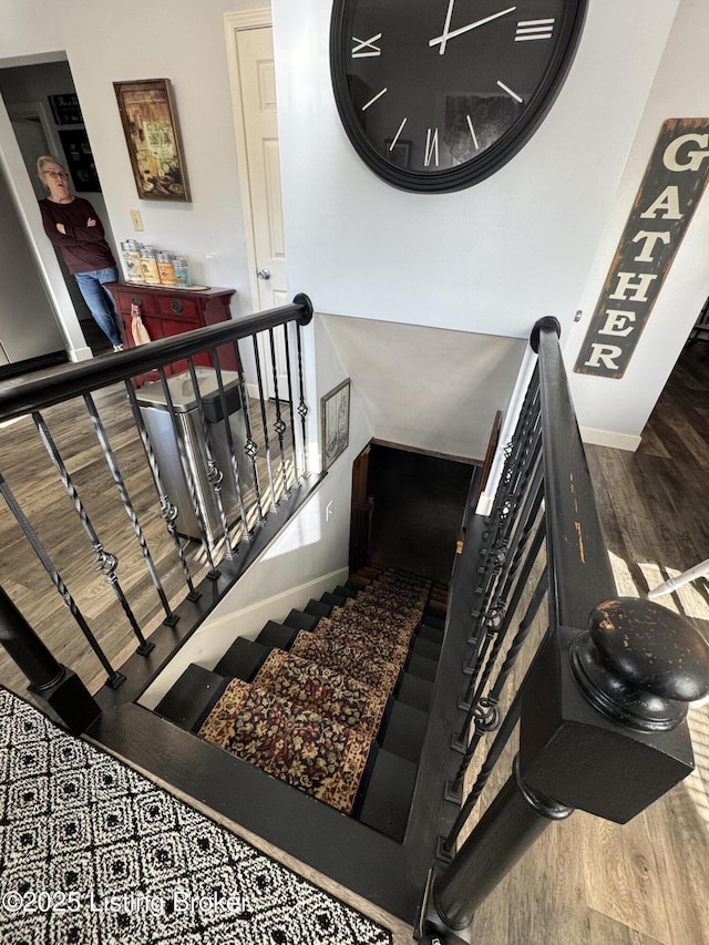 staircase with wood-type flooring