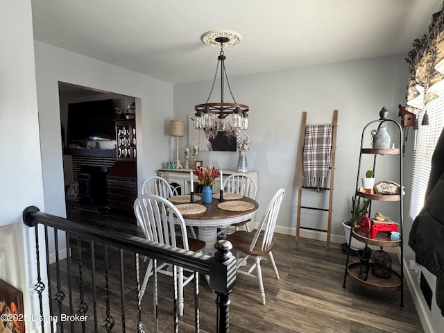 dining room with dark wood-type flooring and a fireplace