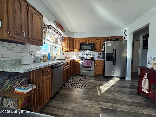 kitchen with tasteful backsplash, sink, dark hardwood / wood-style floors, and appliances with stainless steel finishes