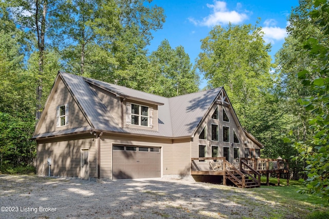 exterior space featuring a wooden deck and a garage