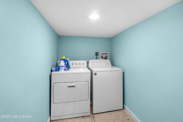 washroom featuring light tile patterned floors and washing machine and clothes dryer