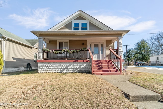 bungalow-style house with covered porch and a front yard