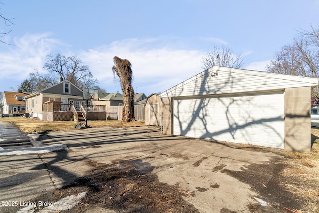 exterior space with a garage and an outbuilding