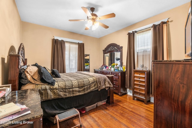 bedroom with ceiling fan and hardwood / wood-style floors