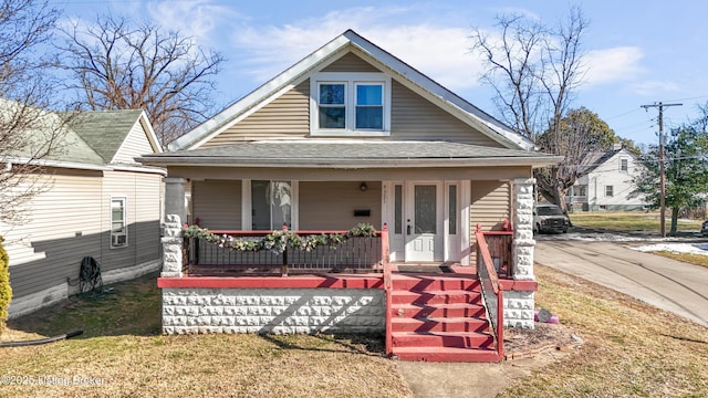 bungalow-style house featuring a front lawn and covered porch