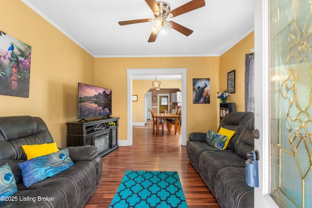 living room with crown molding, ceiling fan, and dark hardwood / wood-style flooring