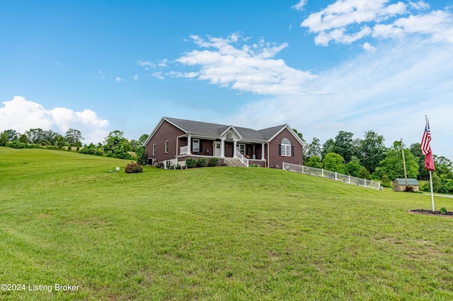 single story home with a porch and a front lawn