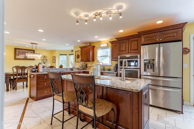 kitchen featuring a breakfast bar area, stainless steel appliances, kitchen peninsula, and a center island