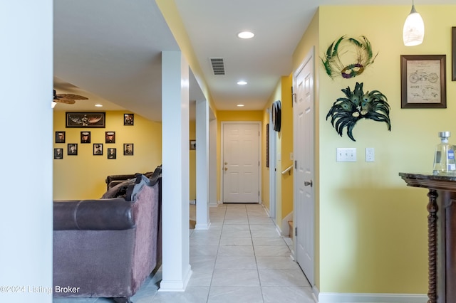 hall with light tile patterned floors