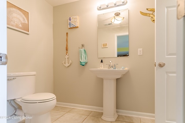 bathroom featuring tile patterned flooring and toilet