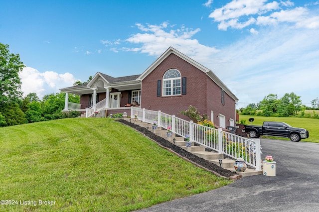 view of front facade featuring a porch, a garage, and a front yard