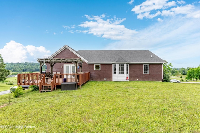 back of house featuring a lawn, a deck, and a pergola