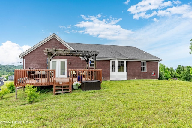 back of house featuring a pergola, a deck, and a lawn