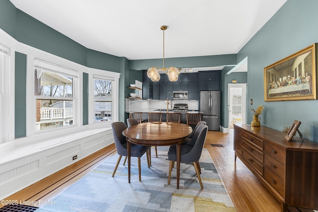 dining room with wood-type flooring