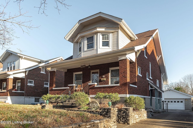 view of front of property featuring an outbuilding, a porch, and a garage