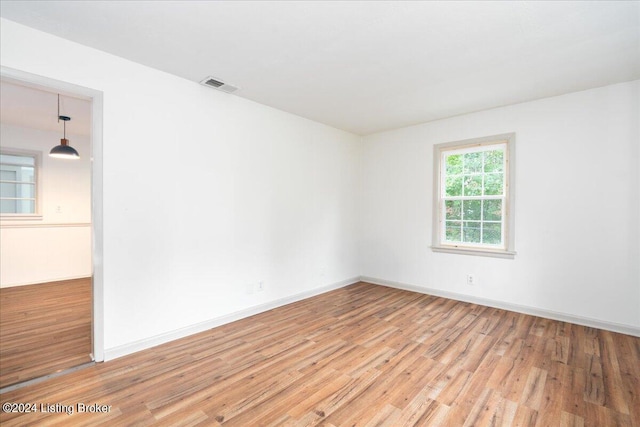 spare room with light hardwood / wood-style floors