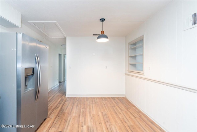 unfurnished dining area featuring hardwood / wood-style flooring and built in features